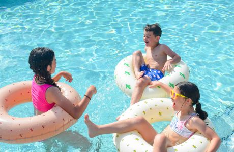A family enjoying time together in a pool.