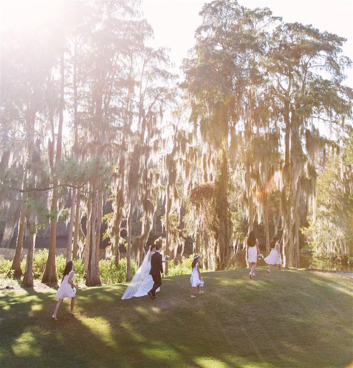 Bride and groom sharing a kiss on the lawn