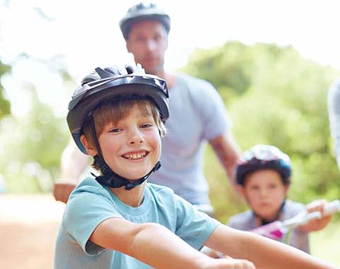 A family smiling on bikes