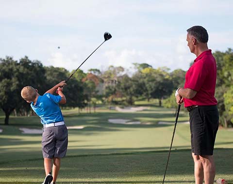 Two people playing golf