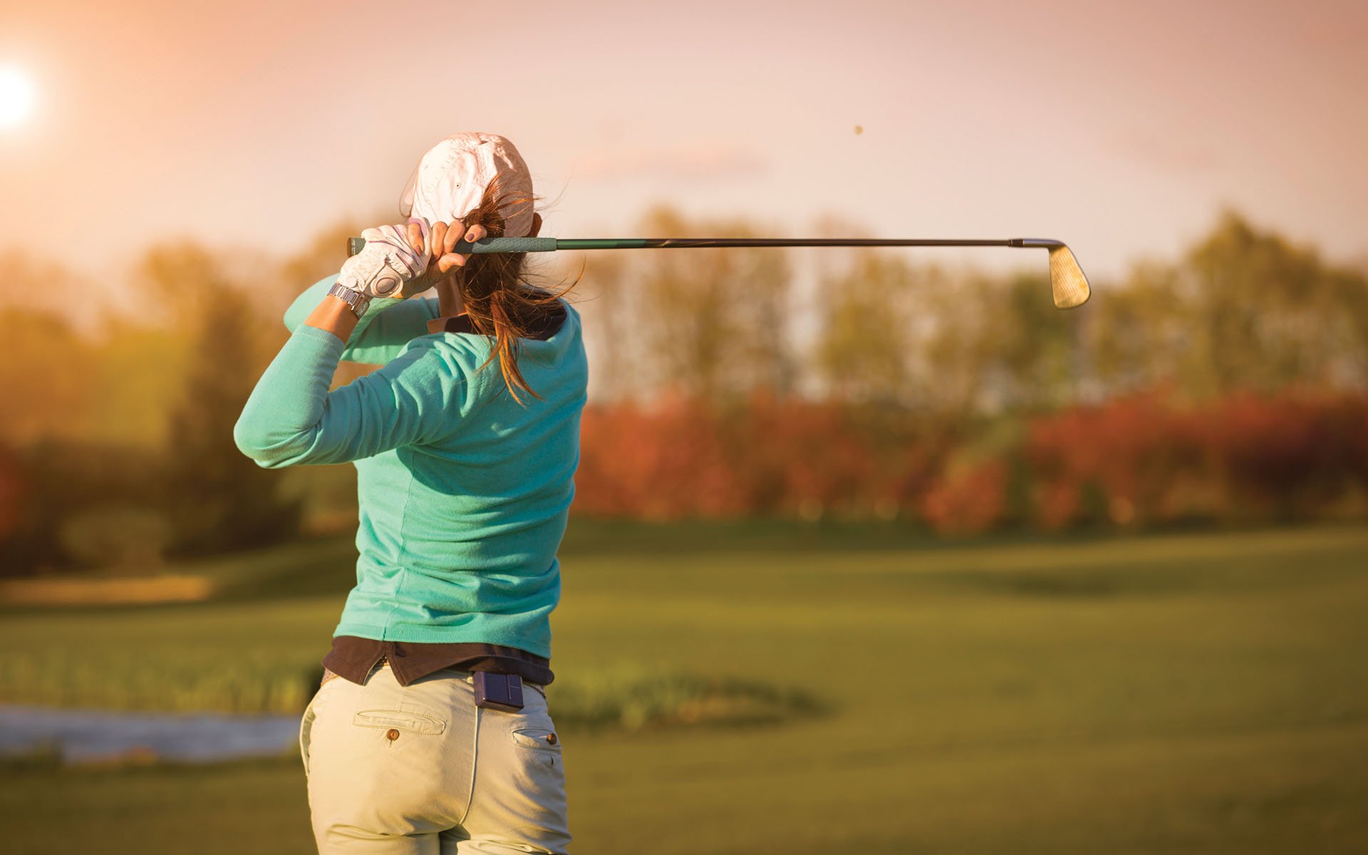 A woman playing golf