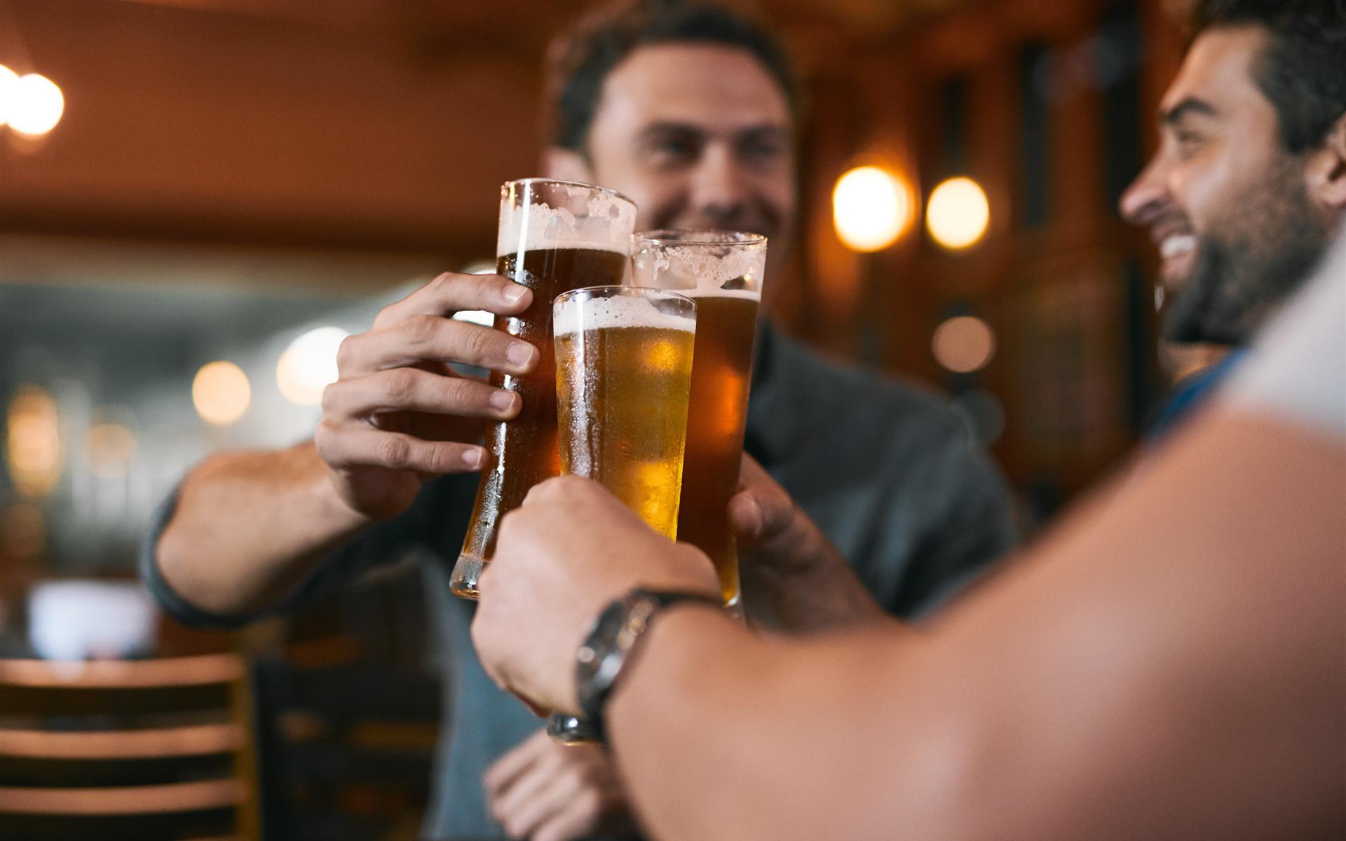 Three guys having a beer