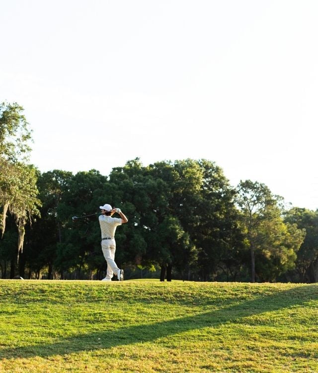 man in his backswing on golf course