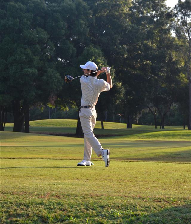 man in his backswing on golf course