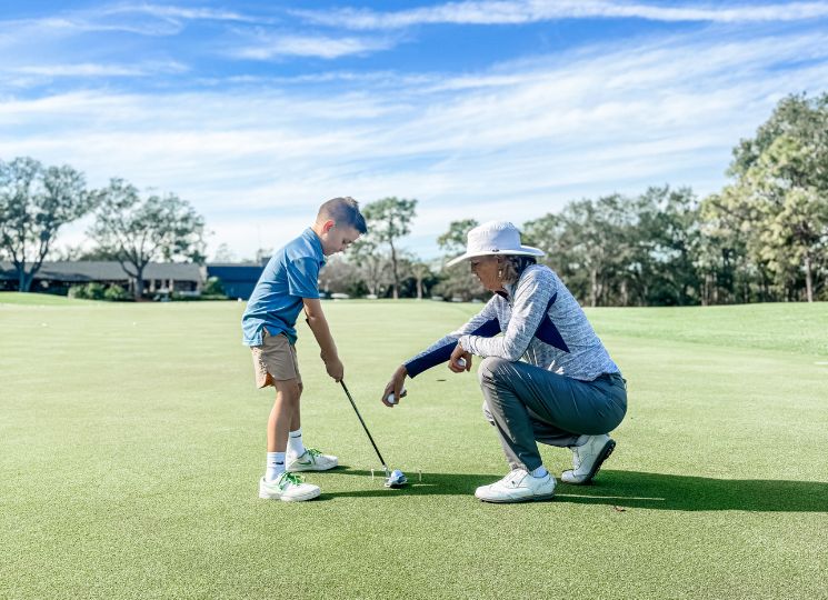 child and golf instructor