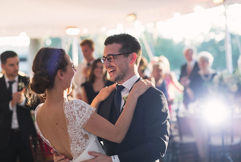 a bride and groom smiling at one another