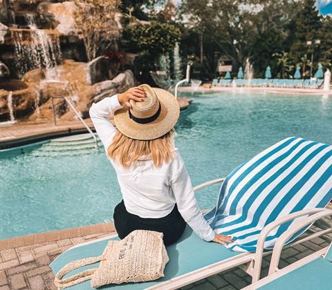 Woman sitting on a chair at pool