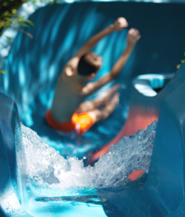 A kid going down a waterslide