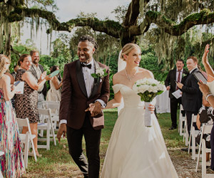 Wedding couple walking down a split aisle outdoors