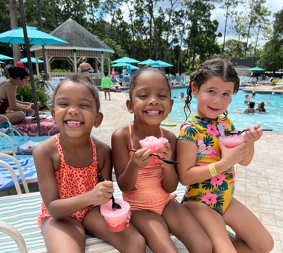 children enjoy a snack poolside