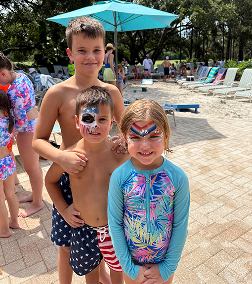 children with face paintings at the pool