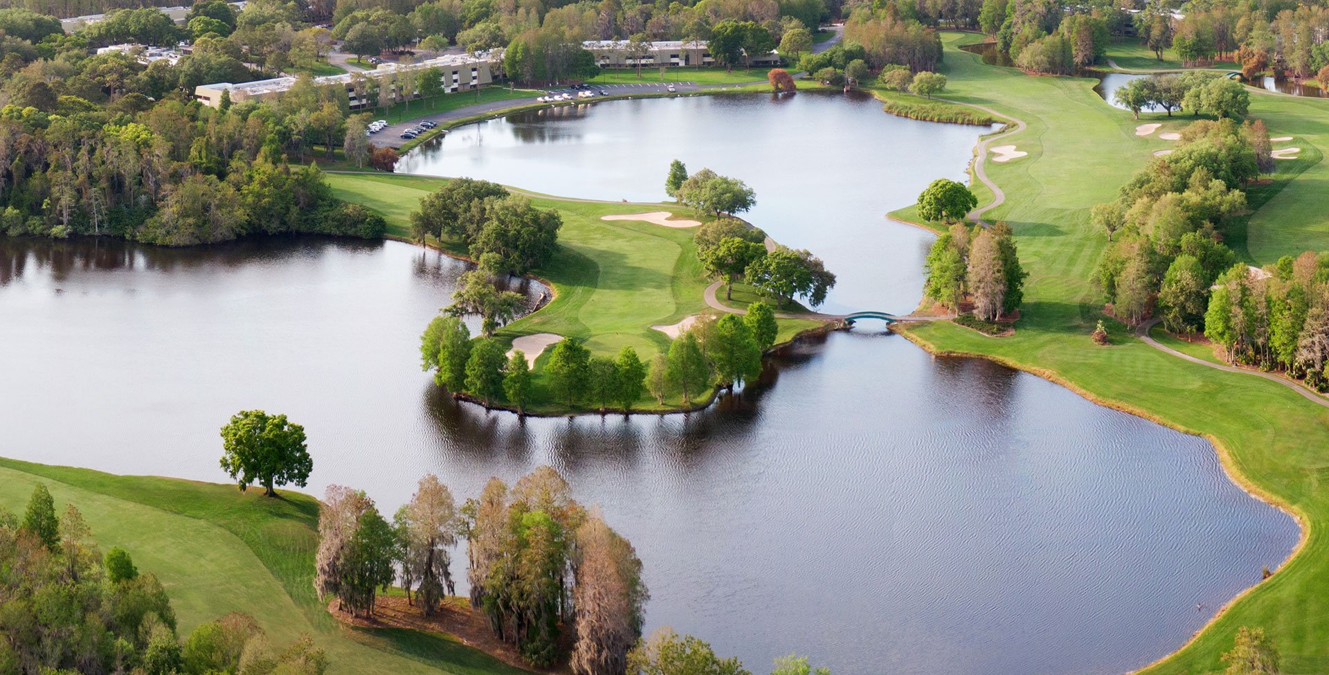 an aerial shot of the golf course and the lakes in it