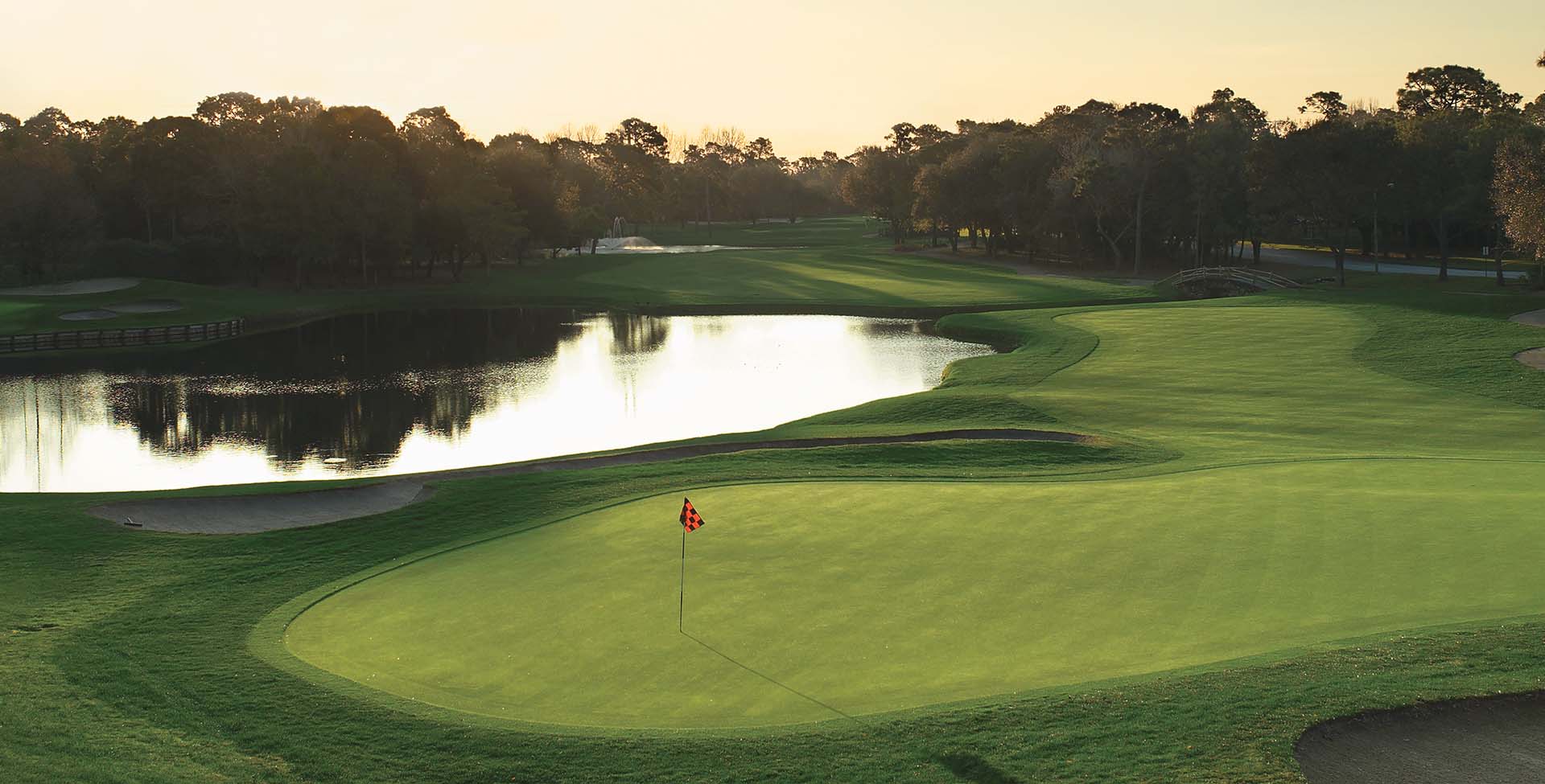 A golf course with a lake next to it