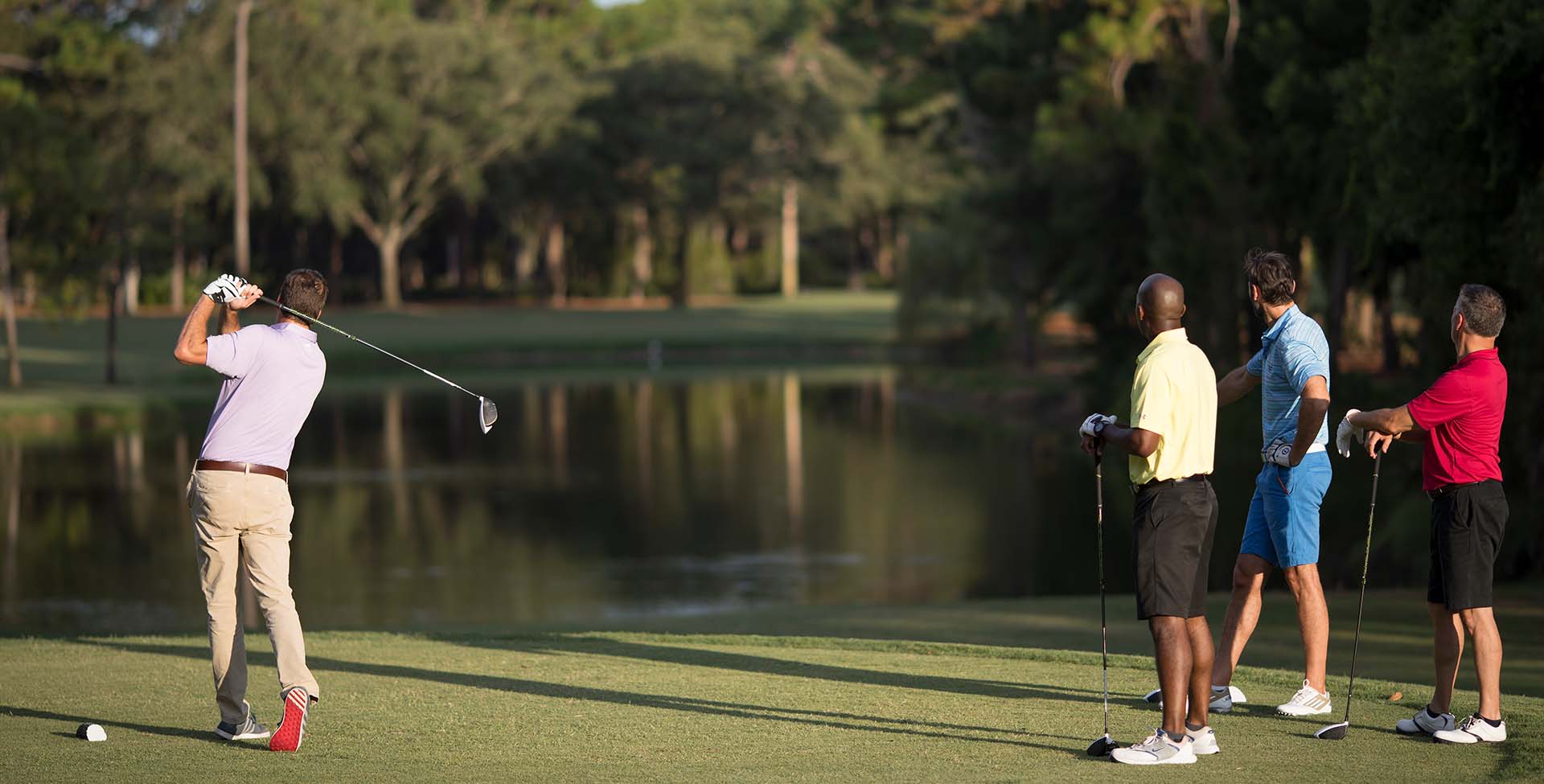 A group of guys playing golf