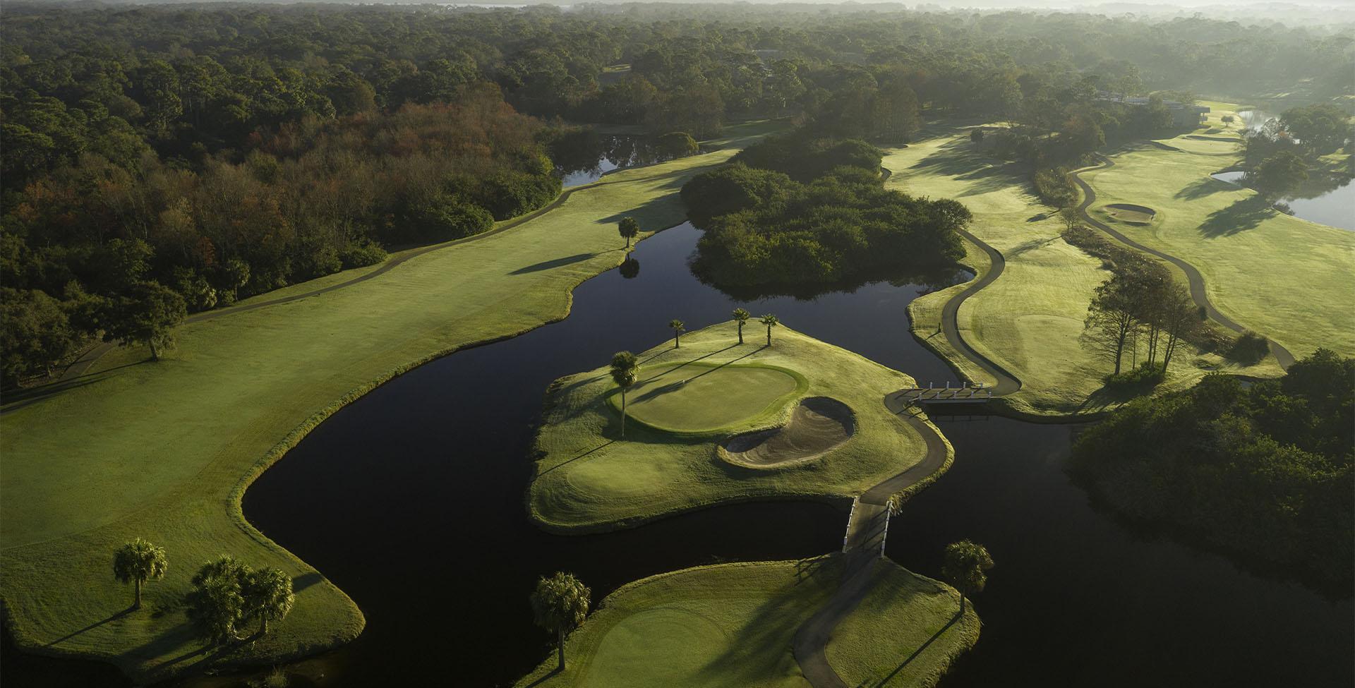 A golf course with water around it