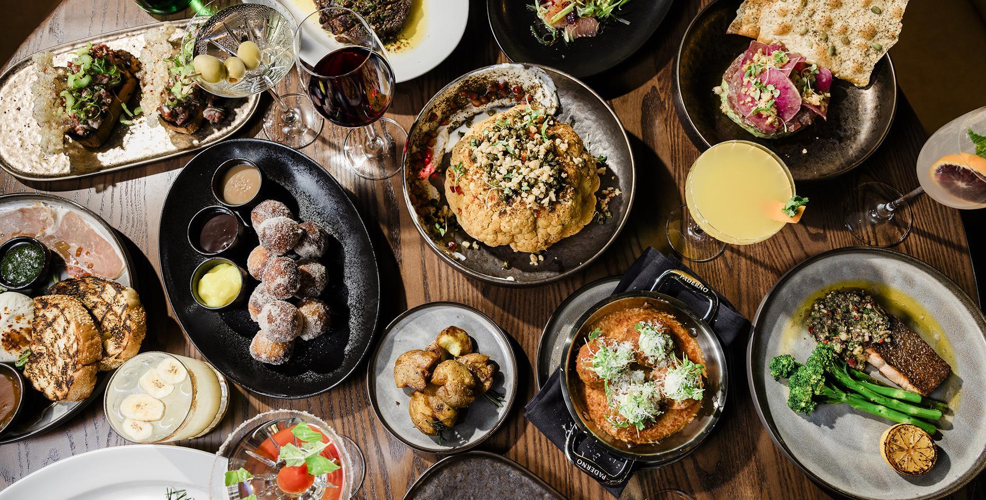 Table filled with various plates of food