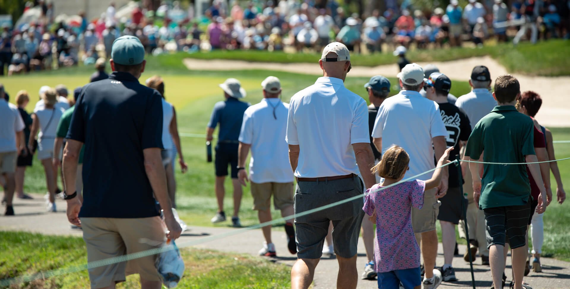 People walking at a golf event