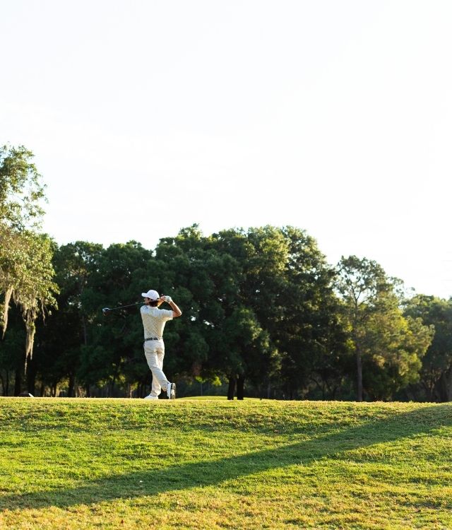man in his backswing on golf course