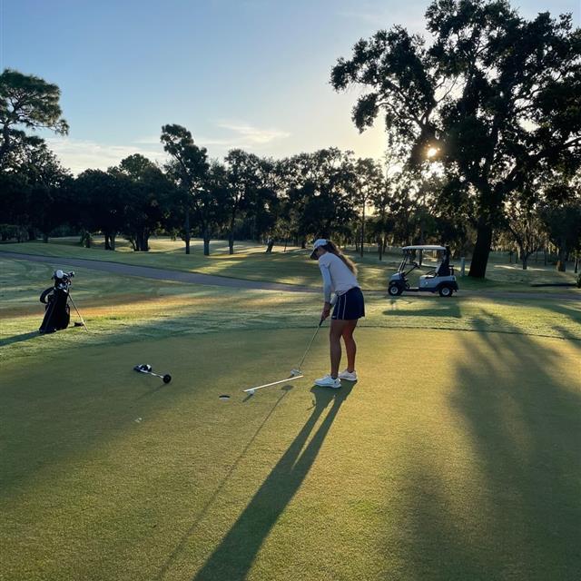 Woman golfing in the morning